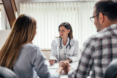 doctor talking to a couple