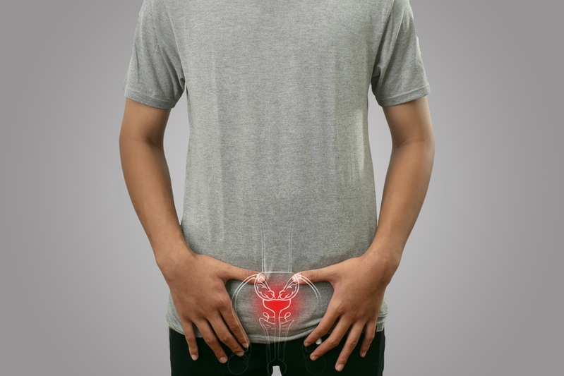 man holding hands over prostate