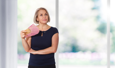 woman battles hot flash due to changes in sex hormones